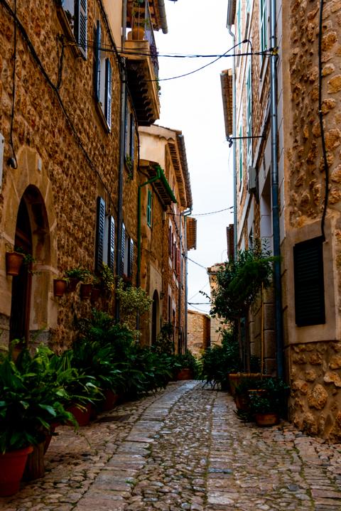 Gasse mit Pflanzen in Fornalutx Mallorca thealkamalsontheroad